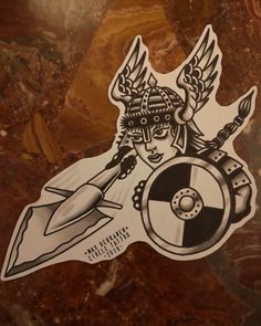 a sticker with an image of a woman holding a rocket and wings on it