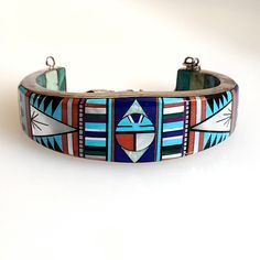 Vintage Zuni Inlay Bracelet Museum Quality Inlay on both on the exterior and interior of the bracelet.  Inside is 19 panels of panels of turquoise and two mother of pearl.  The exterior is extensive inlay consisting of Turquoise, Mother of Pearl, Jet, Opal, and red shell.  A chain connects. Condition - Very Good Vintage Condition- No Damage to any of the inlay Great to add to the collection or to wear out on those special occasions Warning - Most sterling bracelets will deform when adjusted, adj Luxury Sterling Silver Inlay Bracelet, Luxury Multicolor Inlay Bracelets, Sterling Bracelets, Stone Bracelet, Mother Of Pearl, Cuff Bracelets, Shells, Opal, Jewelry Bracelets