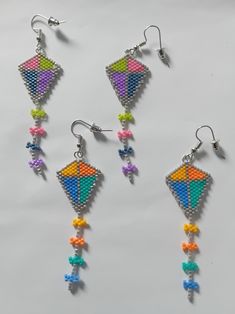 three pairs of colorful beaded earrings with dangling hooks