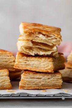 a stack of croissants sitting on top of a white plate