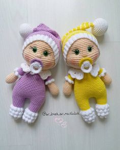 two crocheted dolls laying next to each other