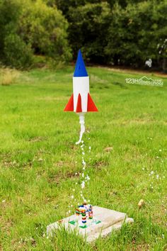 a rocket ship made out of legos in the grass