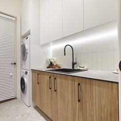 a washer and dryer are in the kitchen next to each other on the counter