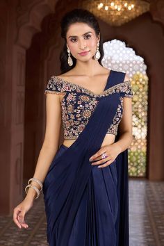 Navy blue pre-draped saree. Comes with floral and geometric embroidered off-shoulder blouse. - Aza Fashions Traditional Blue Pre-draped Saree For Evening, Designer Blue Pre-draped Saree, Blue Draped Lehenga With Unstitched Blouse, Blue Draped Blouse Piece With Zari Work, Designer Draped Blue Lehenga, Blue Draped Bollywood Blouse Piece, Blue Bollywood Draped Blouse Piece, Bollywood Style Draped Blue Blouse Piece, Draped Blue Choli For Reception