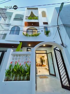 an apartment building with plants on the balcony