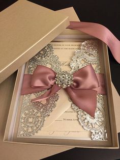 an open box with a pink bow on it