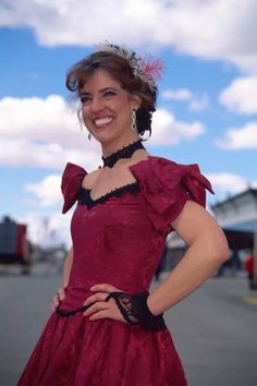 a woman in a red dress posing for the camera