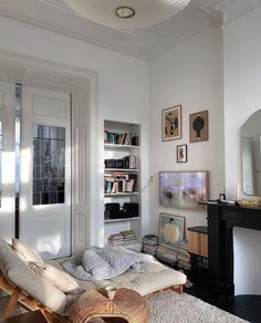 a living room filled with furniture and a fire place