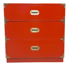 a red file cabinet with three drawers on each drawer and two gold handles, against a white background