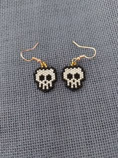 the skull earrings are made out of plastic beads