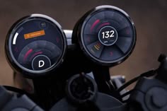 two gauges on the front of a motorcycle with speedometers and numbers displayed