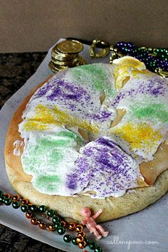 a cake that is on top of a plate with beads and other items around it