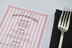 a fork and menu sitting on top of a table