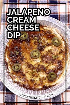 an image of a cheese dip with jalapeno on top in a paper plate