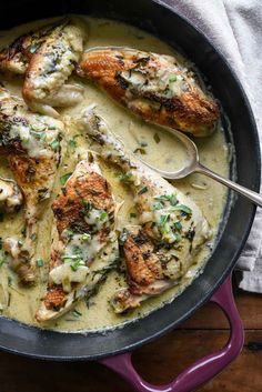 chicken in a creamy sauce with herbs on the side