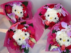 three hello kitty bouquets with pink and white flowers