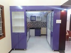 an empty kitchen with purple cabinets and white counter tops in a room that looks like it has been painted