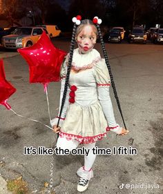 a creepy clown holding two red balloons in her hands with the caption it's like the only time i fit in