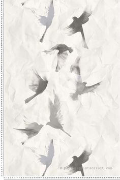 birds are flying in the air on crumpled paper