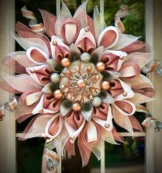 a large pink and white flower on top of a door