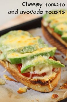 an open faced sandwich with cheese, lettuce and tomato on toasted bread