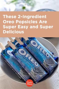 three popsicles are in a bowl with the words, these 2 ingredient oreo popsicles are super easy and super delicious