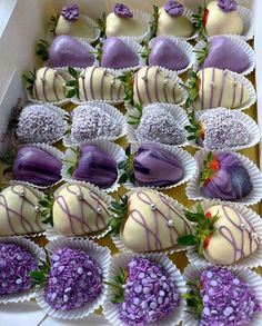 a box filled with lots of different types of chocolate covered strawberries on top of each other