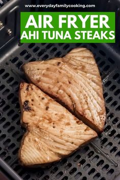 two pieces of cooked fish sitting on top of a grill with the words air fryer ahi tuna steaks