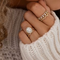 a woman wearing three different rings on her fingers