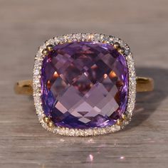 The 6th Avenue: Checkerboard Cut Natural Amethyst And Diamond Halo Cocktail Ring. This Ring Showcases A Central Cushion-Shaped Checkerboard-Cut Natural Amethyst, Embraced By A Halo Of Round Natural Diamonds, Creating An Elegant And Timeless Piece For Any Jewelry Collection. Crafted In 14 Karat Yellow Gold With A Rhodium-Topped Halo, The Ring Not Only Exudes Style But Is Also Comfortable To Wear. Currently Sized At 7.25, It Can Be Adjusted To Any Finger Size For An Additional Charge Upon Request, Ensuring A Perfect Fit For Your Individual Taste And Preference. Amethyst Cocktail Ring, Pink Amethyst, Diamond Halo, Cocktail Ring, Purple Gold, Cocktail Rings, Womens Jewelry Rings, Halo Diamond, Timeless Pieces