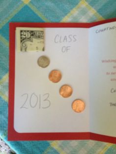 an open book with coins on it and the words class of 2013 written in cursive writing