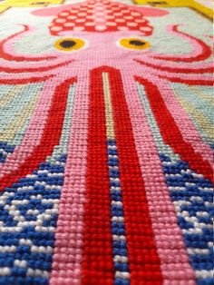 an octopus rug is on the floor with red, white and blue stripes around it