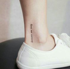 a woman's foot with a small tattoo that says, i love you on it