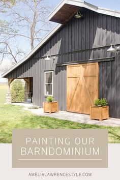 a barn with the words painting our barndominiumum on it and two planters outside