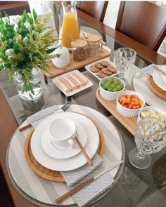 a table set with plates, cups and bowls of food on top of the table