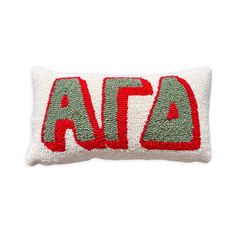 an embroidered pillow with the word atta in red, green and white on it