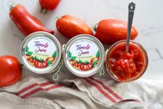 two jars of tomato jam next to tomatoes