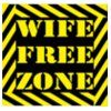 a black and yellow sign that says wife free zone