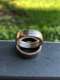 Everyone has a year that means something to them. What better way to commemorate that than with a 2 sided coin ring made from a genuine 1965 to 1998 US quarter. These coinrings are handcrafted in Texas, USA. Choose your ring size and finish (antique shown in photos).  Each ring will show both the inner and outer detail.  By default these rings will show the heads side of the quarter (year and Liberty) on the outside.  When placing your order please let me know which year quarter that you would like.  If you would like the heads side on the inside of your ring and the tails side outside please let me know when you place your order as well.  Thank you for looking. Antique Show, Coin Ring, Texas Usa, A Year, Band Rings, Jewelry Rings, Etsy Accessories, Ring Size, Texas