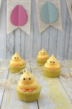 small cupcakes with yellow frosting and decorations