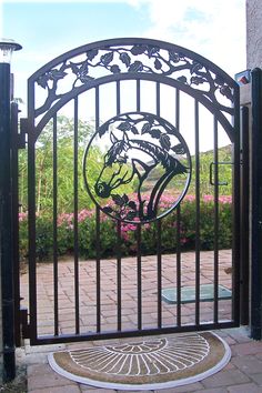 an iron gate with a horse design on it