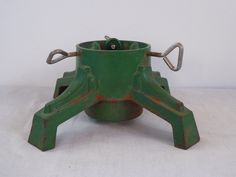 an old green metal device with two handles