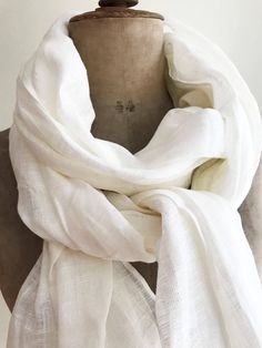 "Lovely, gauzy, lightweight white linen scarf in a generous size. Wonderful linen texture, natural wrinkles. Made from high quality 100% European linen. Edges are frayed for more casual look and fixed to prevent further fraying. A great item in your wardrobe that will be joy to wear in summer as well as in winter. Dimensions: approximately 29.5\" x 78.7\" [75 x 200 cm] Care instructions: - gentle wash cycle - preferably lukewarm water - straighten and hang to dry - It will become softer with eve Classic White Scarf For Gift, White Cotton Scarf As Gift, White Cotton Scarves As Gift, Shawl For Men, Linen Shawl, Big Scarf, Linen Scarf, White Scarf, Linen Scarves