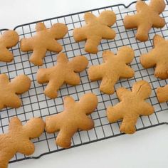 some cookies are cooling on a rack with the words easy gingerbread recipe written in red