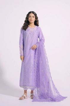 An aesthetically appealing composition is portrayed on this graceful outfit rendered in an appealing lilac shade. It features a classy silhouette shirt beautifully adorned with intricate embroidery at front and sleeves illustrating captivating floral designs with schiffli technique. Paired with a gracefully draped embroidered dupatta with scalloped borders, this gorgeous outfit is a style statement for formal gatherings this season. -Lilac Color -Fabric: Lawn Shirt & Nylon Stripe Dupatta -2 piece Elegant Semi-stitched Purple Sets, Feminine Embroidered Sets For Eid, Floral Embroidered Lawn Suit For Wedding, Festive Purple Lawn Suit With Resham Embroidery, Elegant Festive Embroidered Dress With Intricate Embroidery, Festive Elegant Dress With Intricate Embroidery, Festive Elegant Embroidered Dress, Designer Embroidered Purple Lawn Suit, Formal Spring Lawn Suit With Chikankari Embroidery