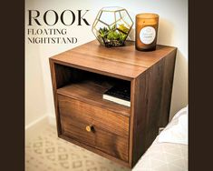 a wooden night stand with a plant on top and a candle next to it that reads, root floating nightstand