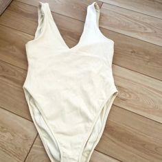 This Beautiful One Piece Has Never Been Worn. It’s Very Flattering! V Neck And Ribbed Pattern. No Stains Or Flaws. From A Pet Free Smoke Free Home. Summer Cream Bodysuit For Loungewear, Cream Bodysuit For Summer Loungewear, White V-neck Bodysuit For Loungewear, Cream Sleeveless Bodysuit For The Beach, Beige V-neck Bodysuit For Spring, Spring Beige V-neck Bodysuit, Spring Beige Lined Bodysuit, Summer Ribbed One-piece Bodysuit, Beige One-piece Bodysuit For Spring