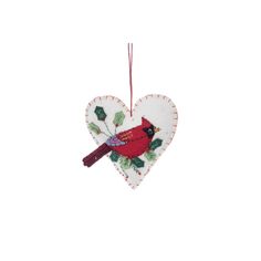 a heart shaped ornament with a red bird on it's back hanging from a string