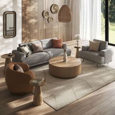 a living room filled with lots of furniture next to a large glass window and wooden floor