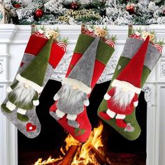 three christmas stockings hanging over a fire place